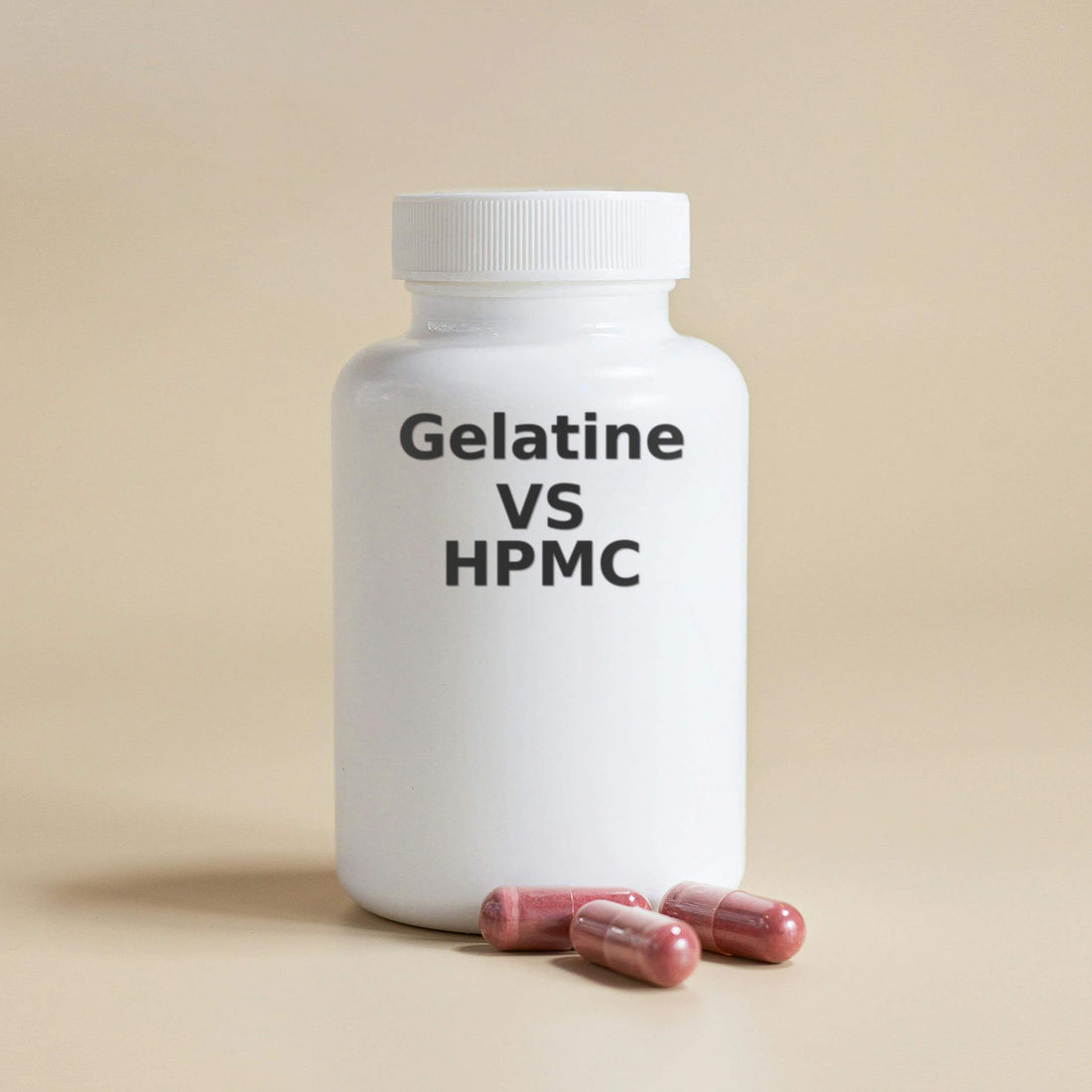 White plastic supplement bottle with black text reading 'Gelatine VS HPMC', with three pink capsules placed in front of it on a beige background.